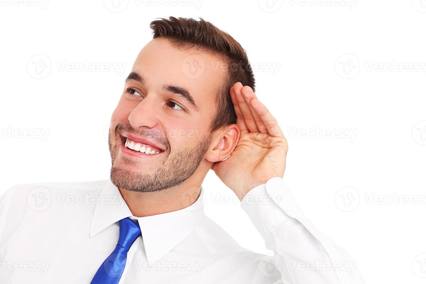 Happy businessman listening to something photo