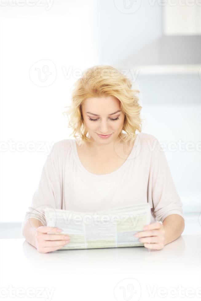 Woman reading paper in the morning photo