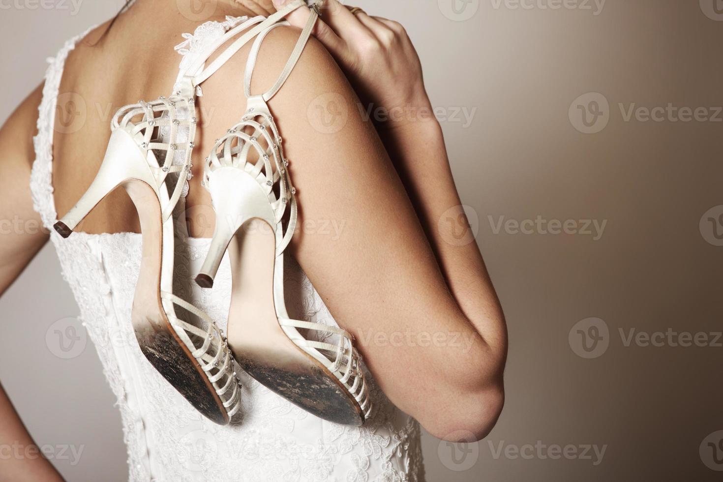 Bride with worn-out shoes photo