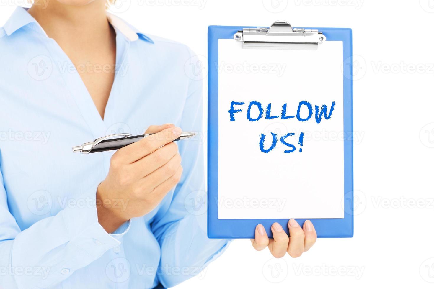 Woman with follow us sign photo