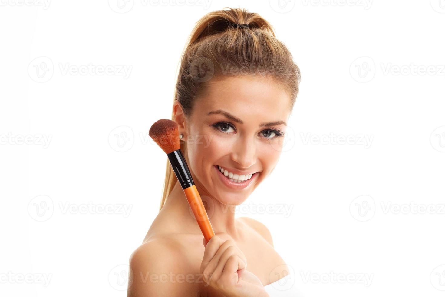 Beauty portrait of adult woman with the makeup brush isolated on white photo