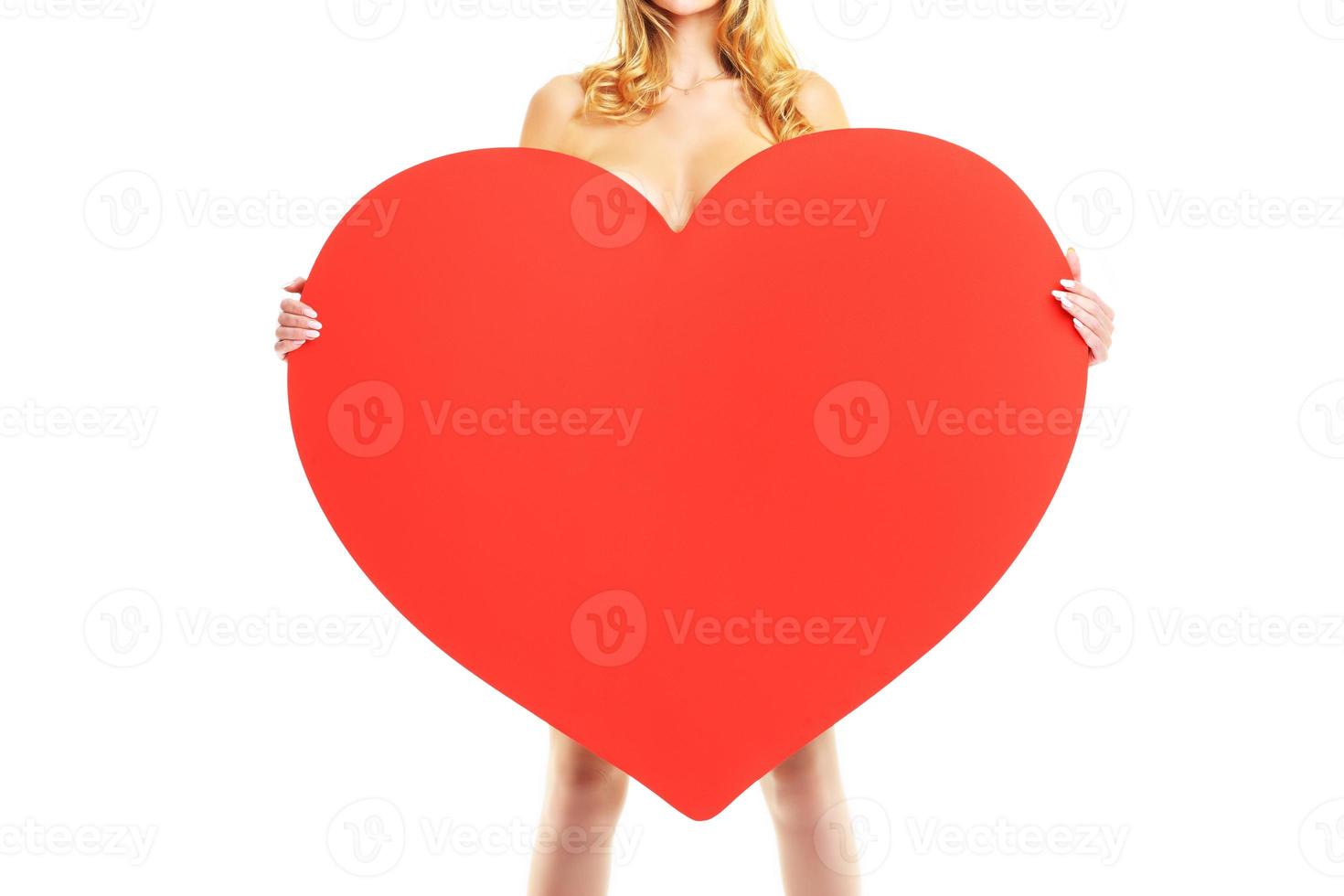 Sexy Valentine woman holding a big heart photo