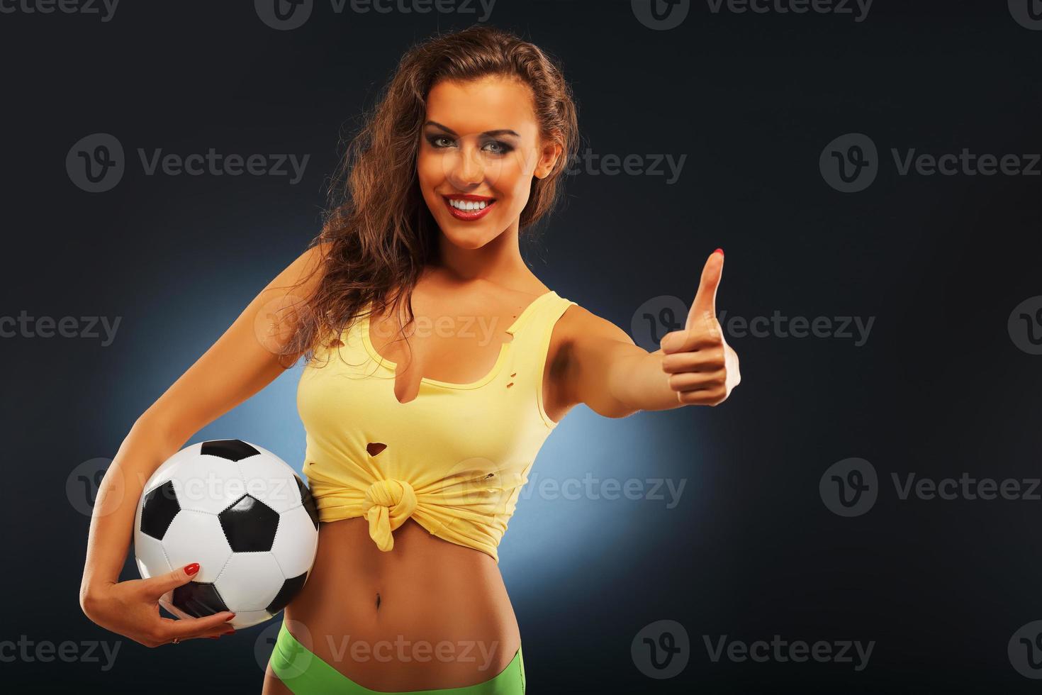 Happy fan cheering with football photo