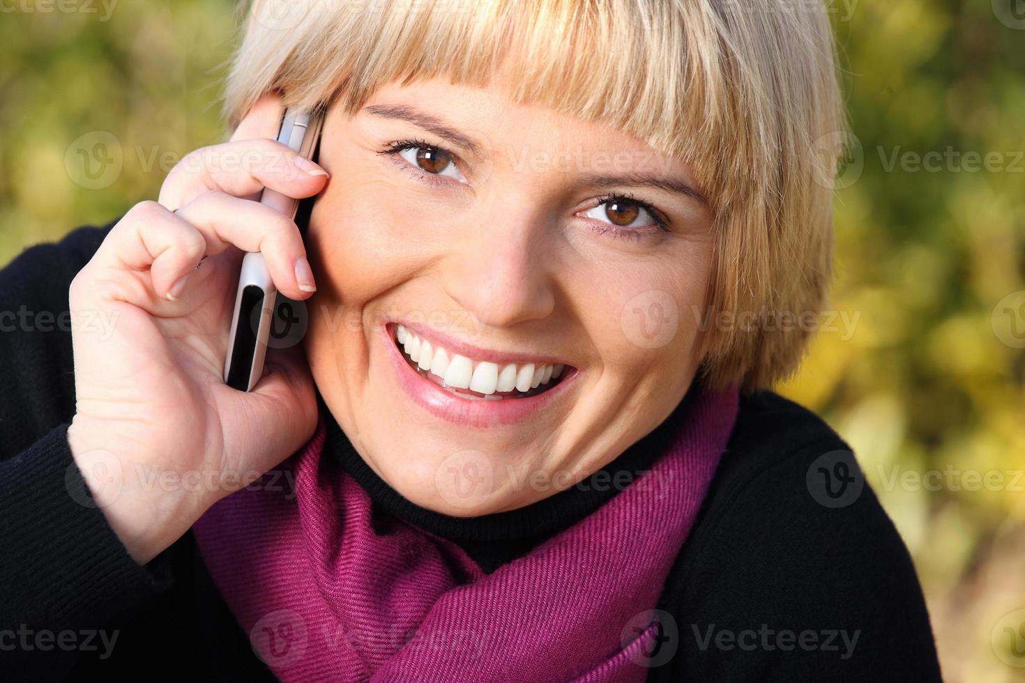 Beautiful young woman talking on the phone photo