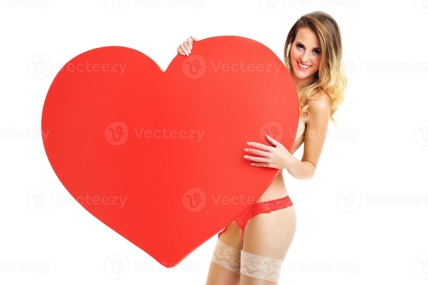 Sexy Valentine woman holding a heart photo