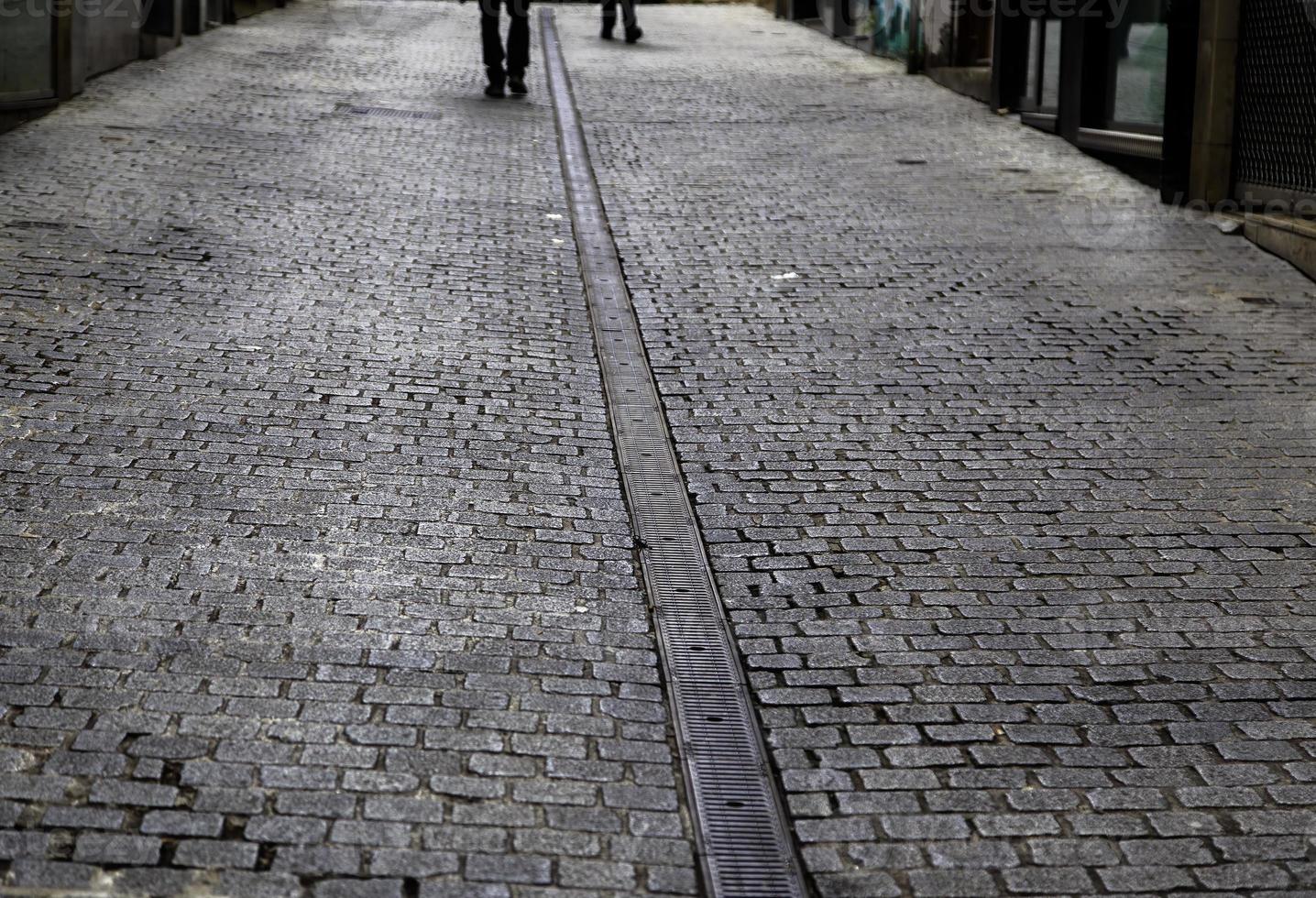 Feet walking on cobblestones photo