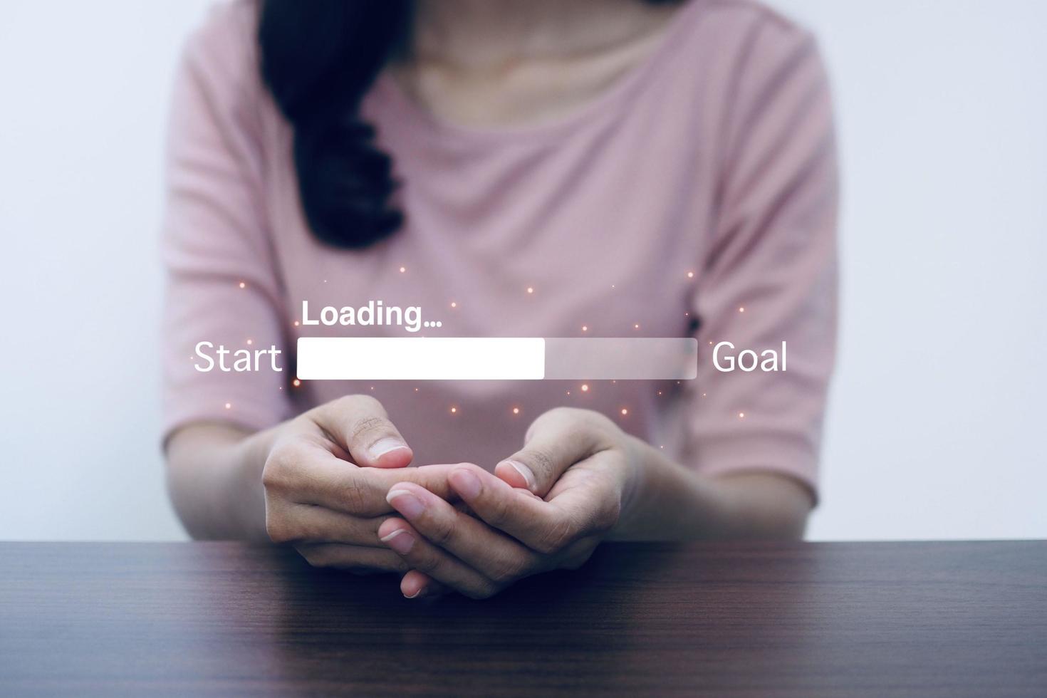 Woman's hand holding countdown bar for loading success start to goal. photo