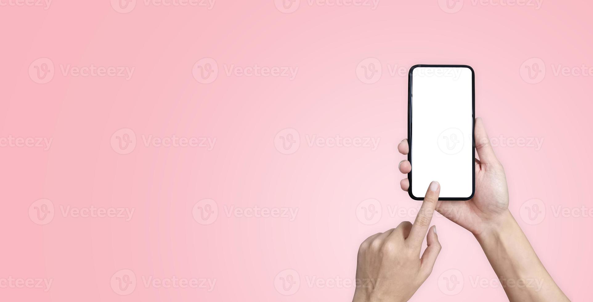 hand and phone on pink background photo