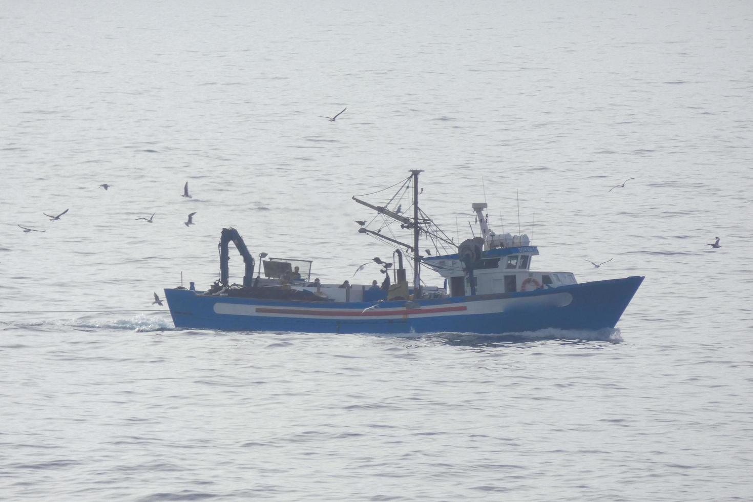 Fishermen returning from fishing at dawn after spending the whole night at sea. photo