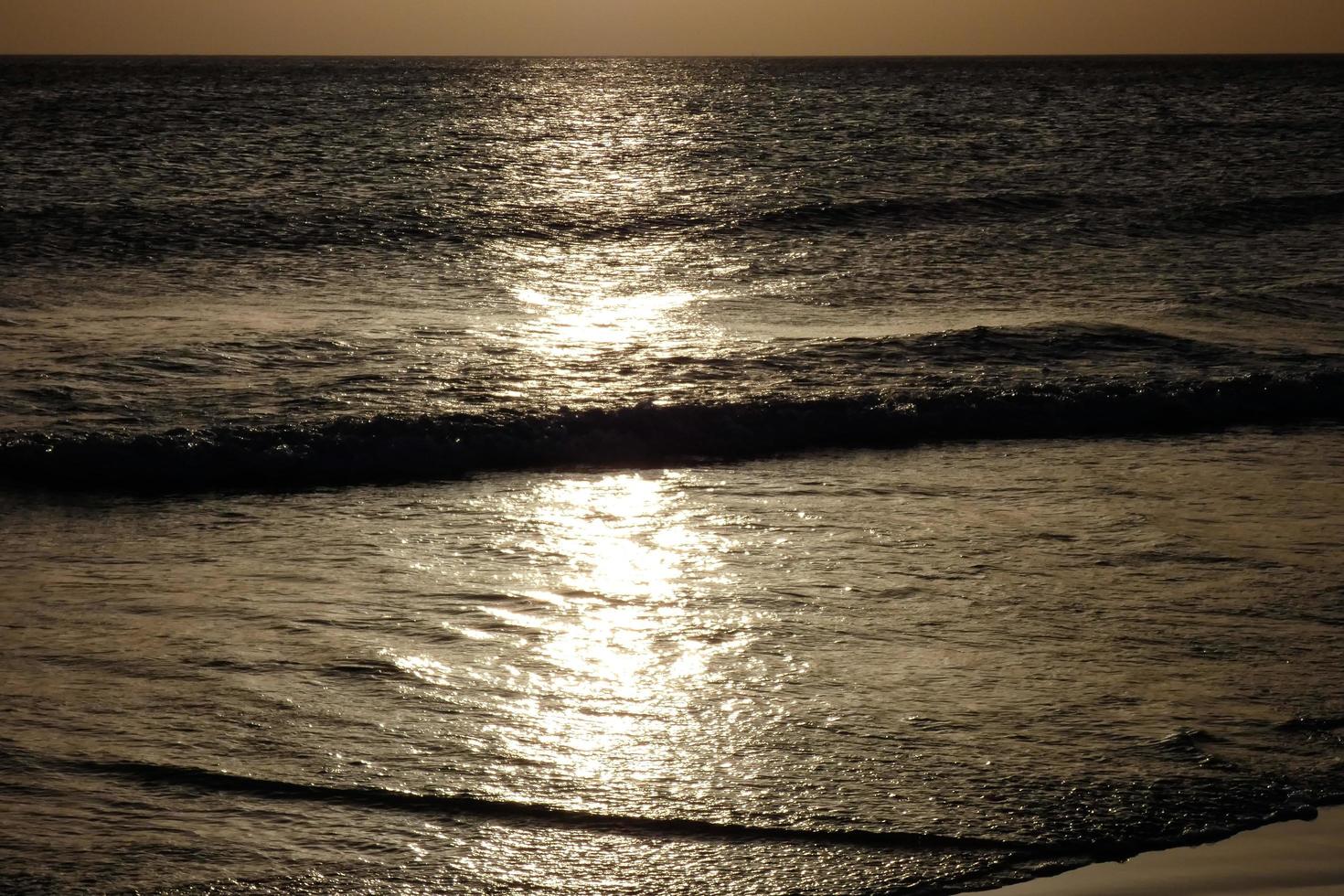 lonely, uncrowded beach with calm sea and small waves photo