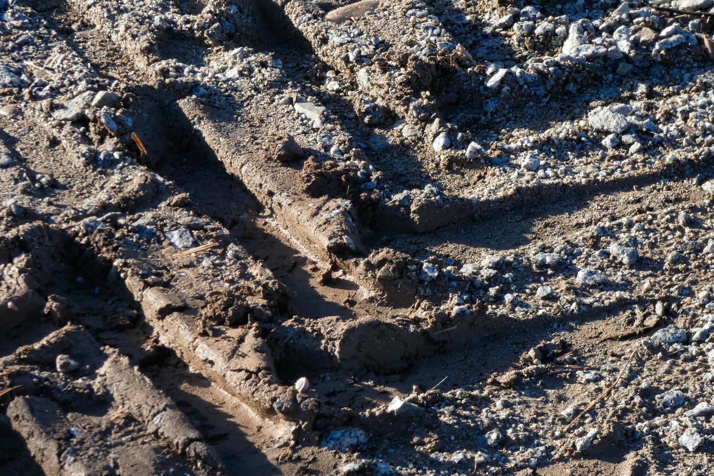 footprint of a tractor or heavy machine in the mud photo