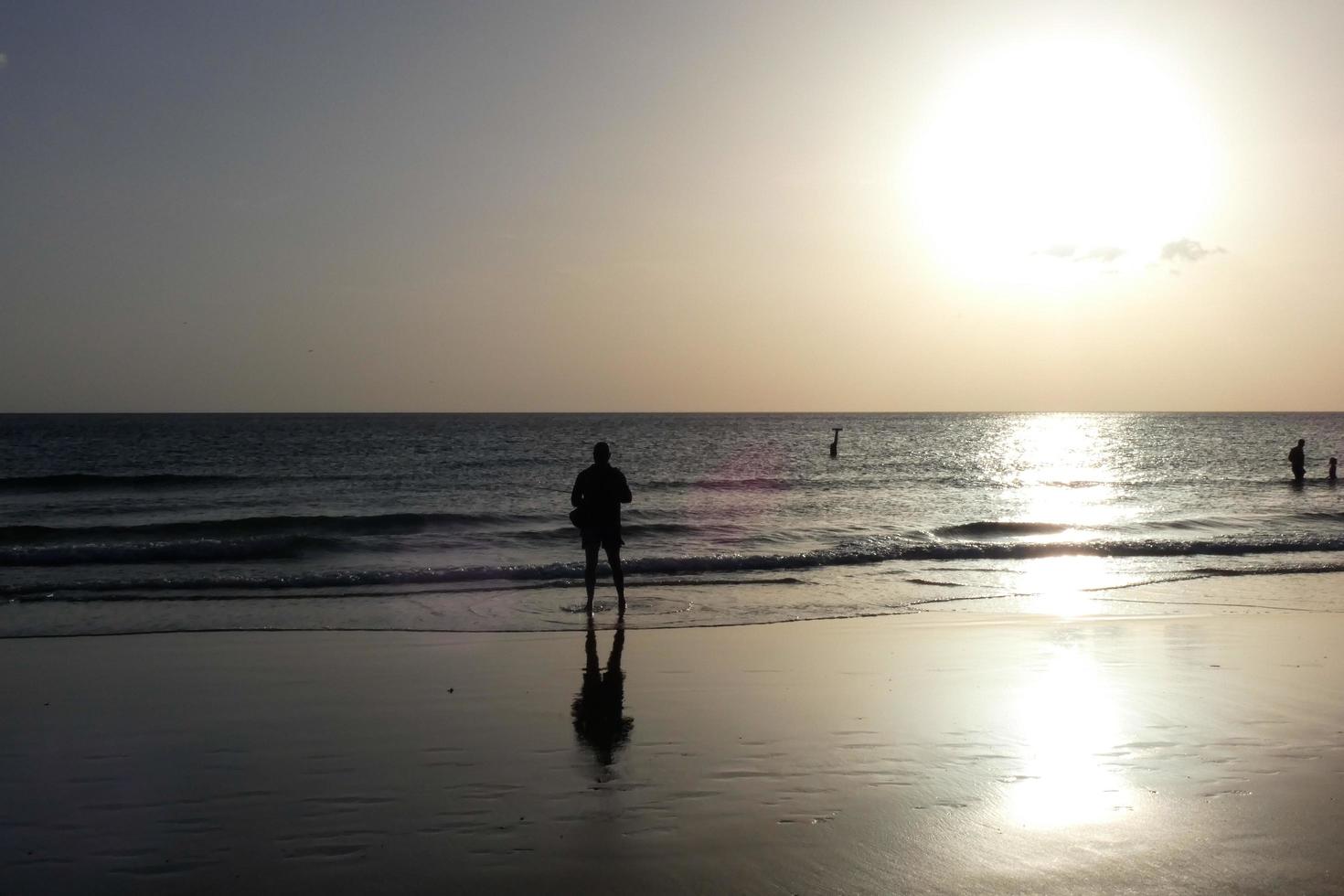 Sun setting over the sea, sunset in autumn on the beach of Zahara de los atunes, Cadiz, Andalucia, Spain photo