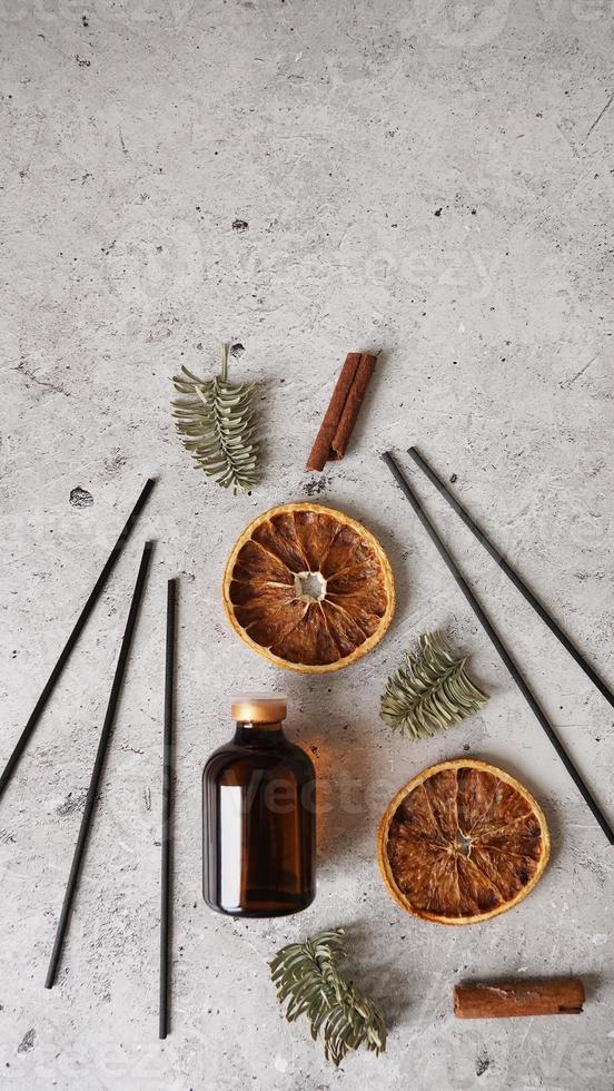 Citrus reed diffuser with cinnamon, dry orange and fir tree branches. photo
