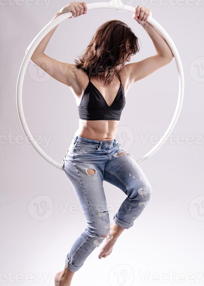 A female Aerial hoop gymnast  performing exercises on an Aerial hoop photo