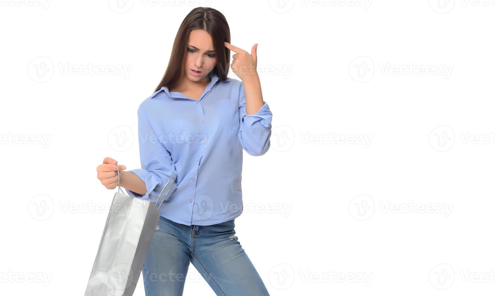 Shopping concept. Beautiful smiling brunette with shopping bags posing on white background photo