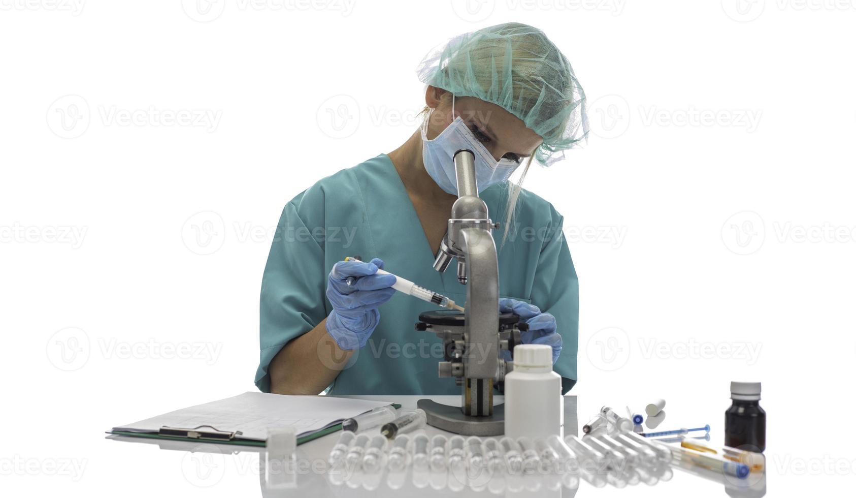 Scientist in blue medical gloves and uniform learning COVID-19 samples with microscope in laboratory. photo