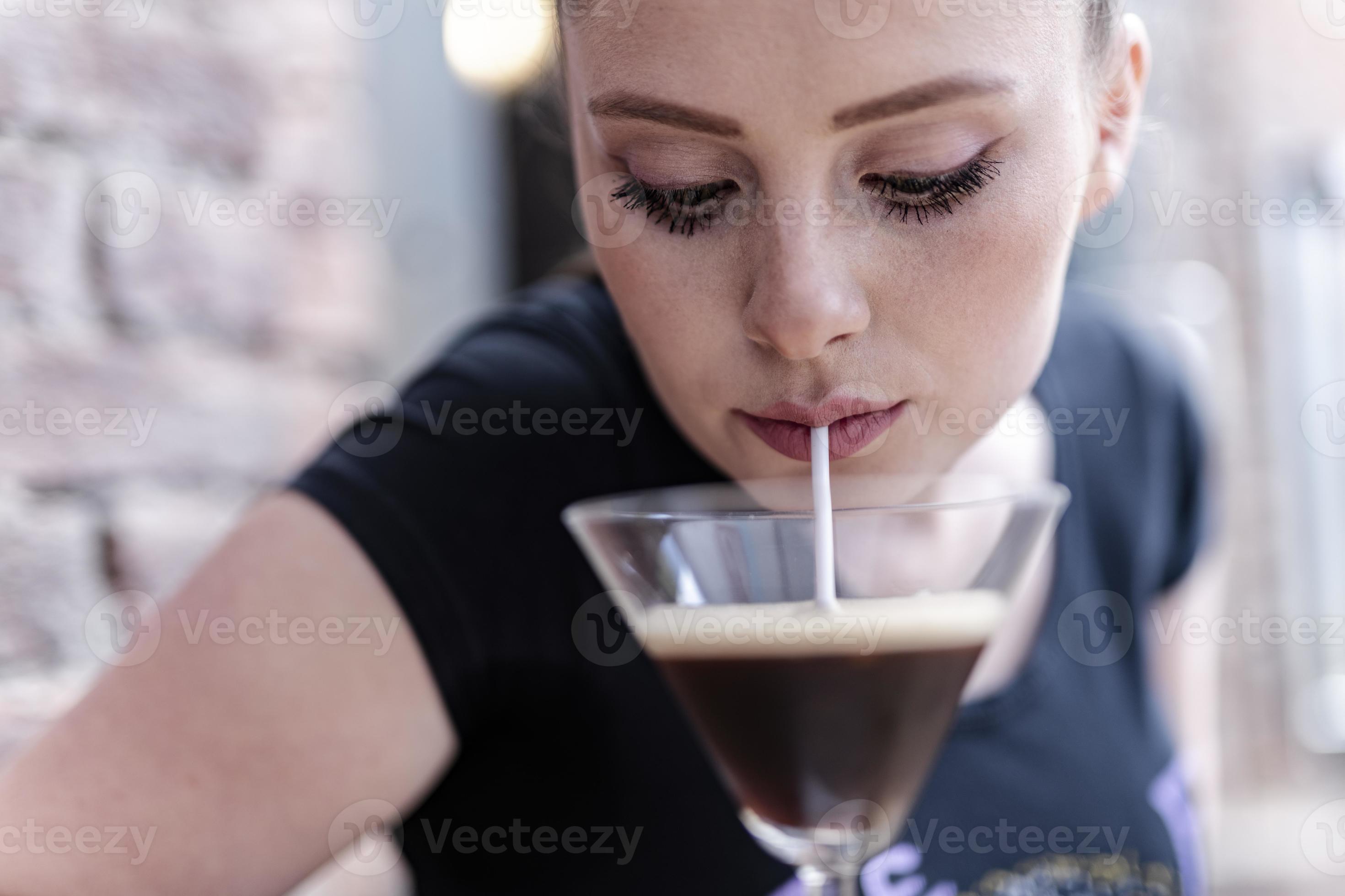 young woman drinking alcohol cocktail with Coffee beans in it. 15899030 Stock Photo at Vecteezy