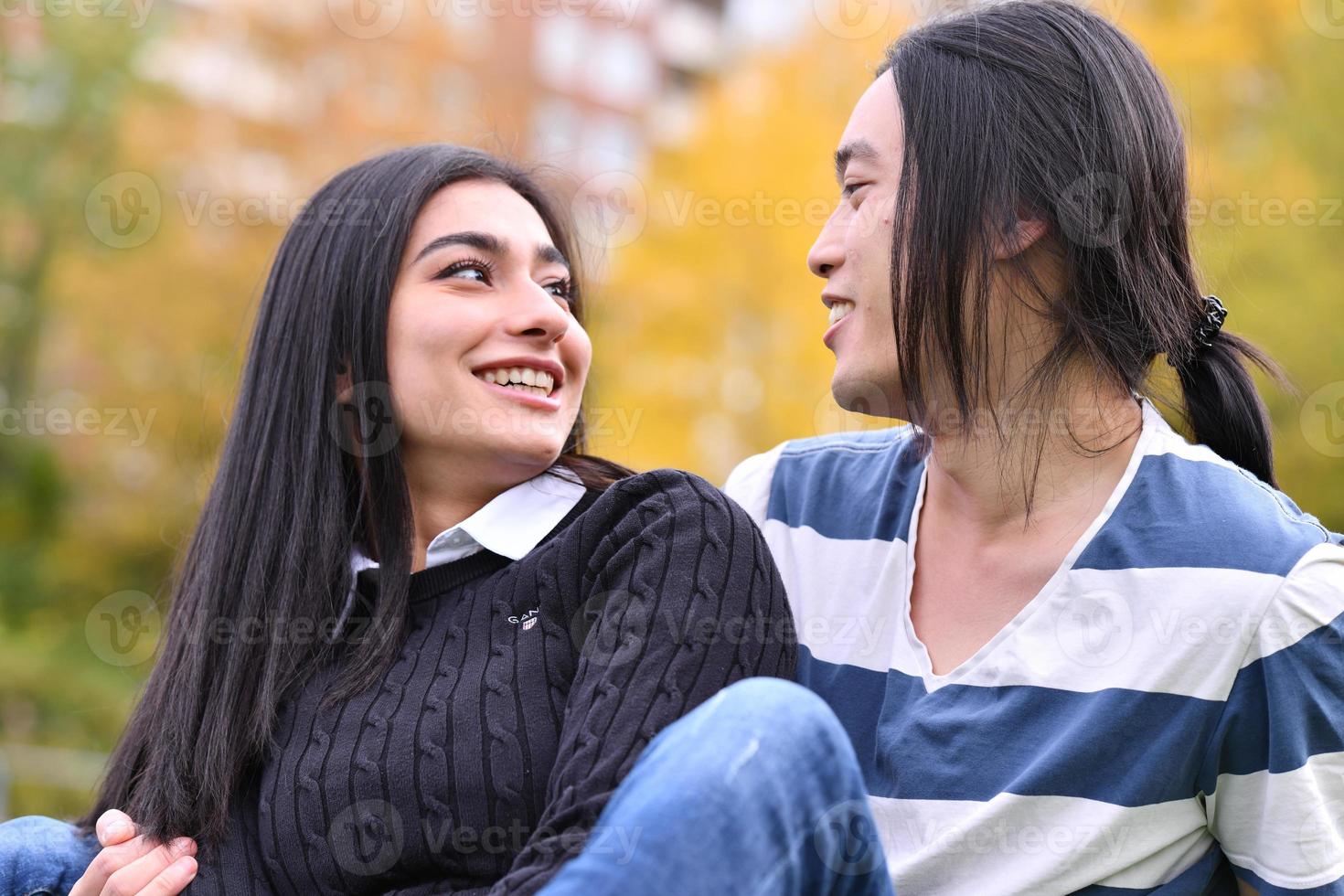 Mixed Couple relaxing In the park photo