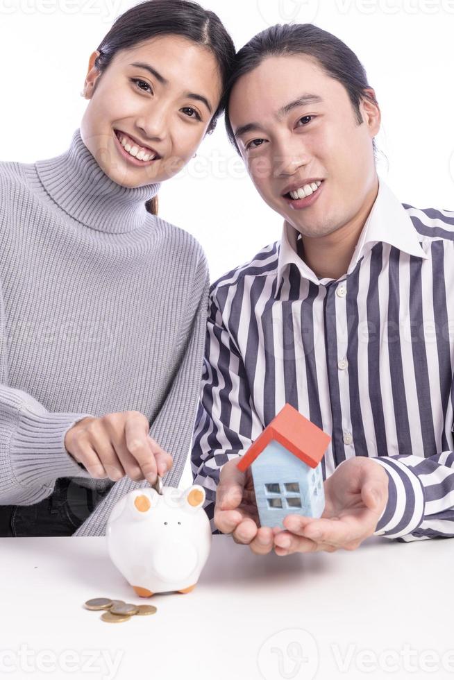 couple saving money in piggy bank photo