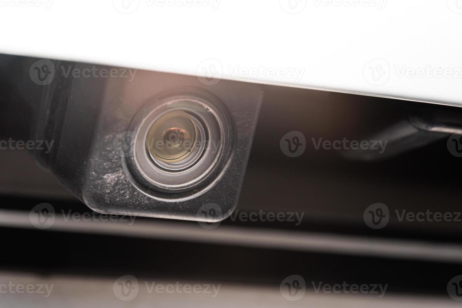 rear view camera close up for parking assistance. Concept of safety car driving while parking process. Assist device equipment in modern cars. Small camera attached to car photo