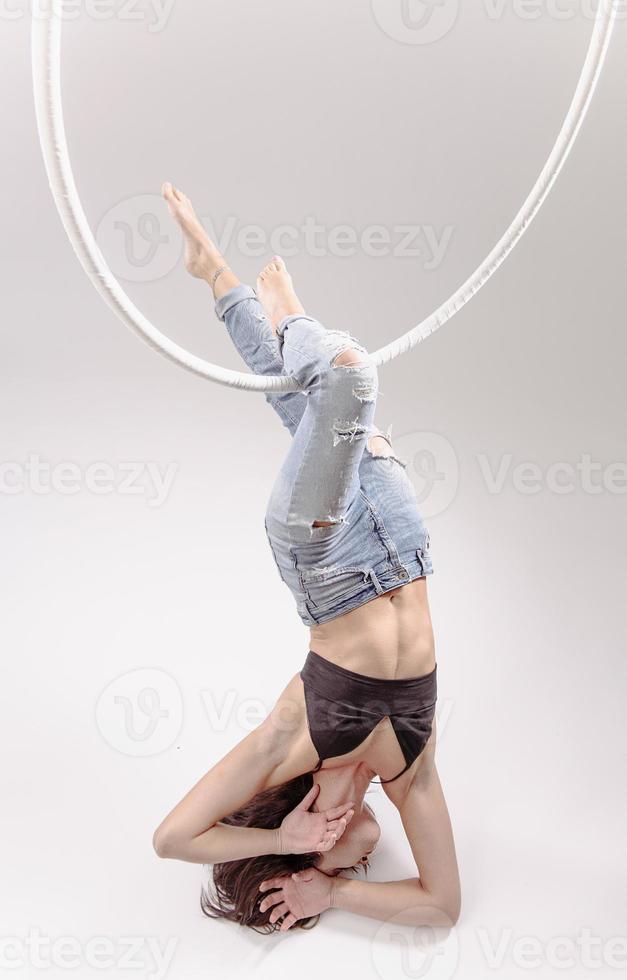 A female Aerial hoop gymnast  performing exercises on an Aerial hoop photo