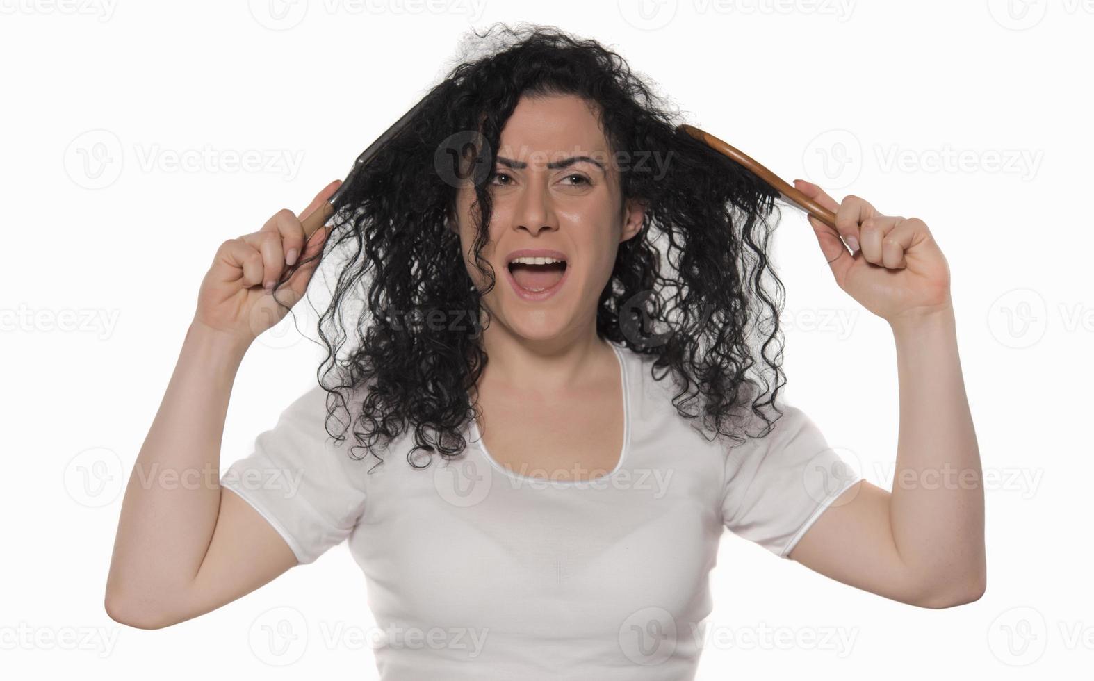 beautiful female with comb stuck in curly hair photo