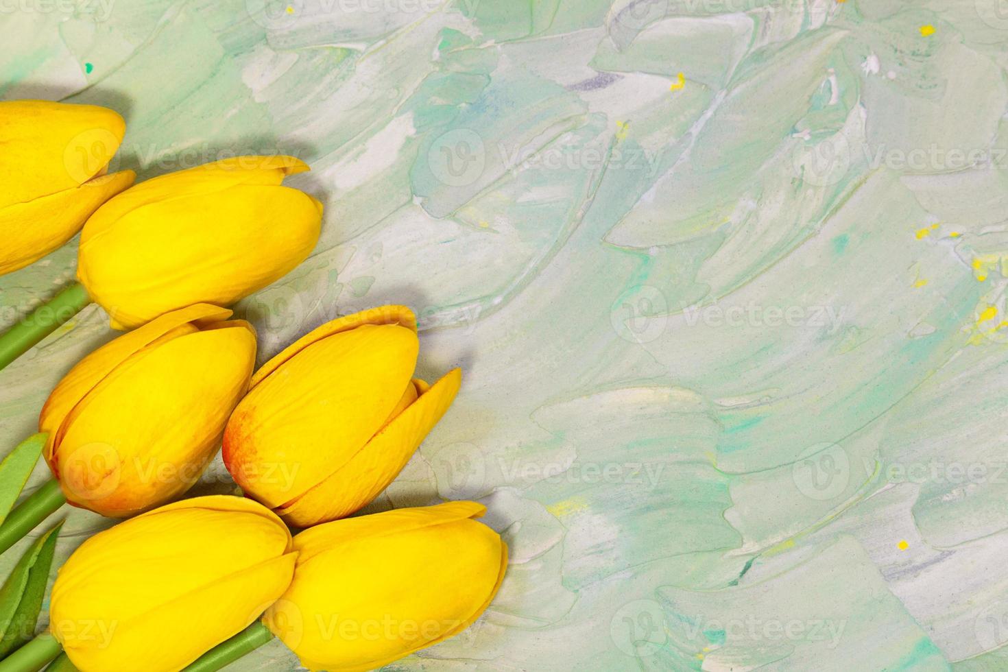 Yellow tulips on green background with brush strokes. Spring card. Women's day, Easter, birthday. Copy space photo