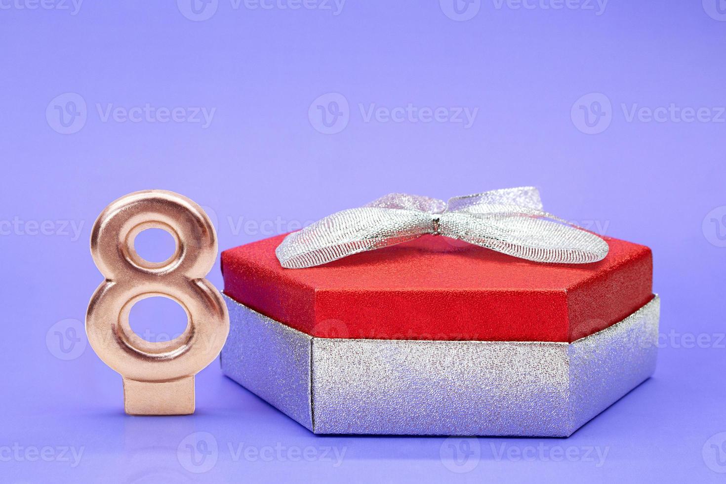 Shiny box red silver with bow and number 8 on lilac background. International Women's Day, 8 March, Birthday. Copy space photo