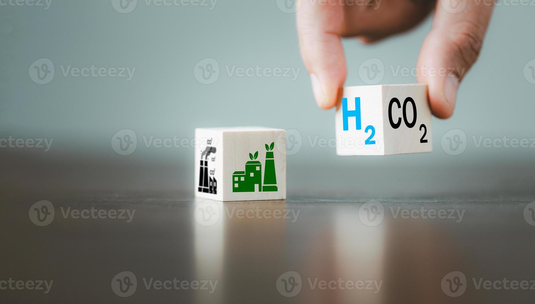 Free Carbon, alternative energy and global climate change concepts. Hand flipping wooden cube blocks with CO2 Carbon dioxide, change to H2 Hydrogen text on table background. Sustainable car energy. photo