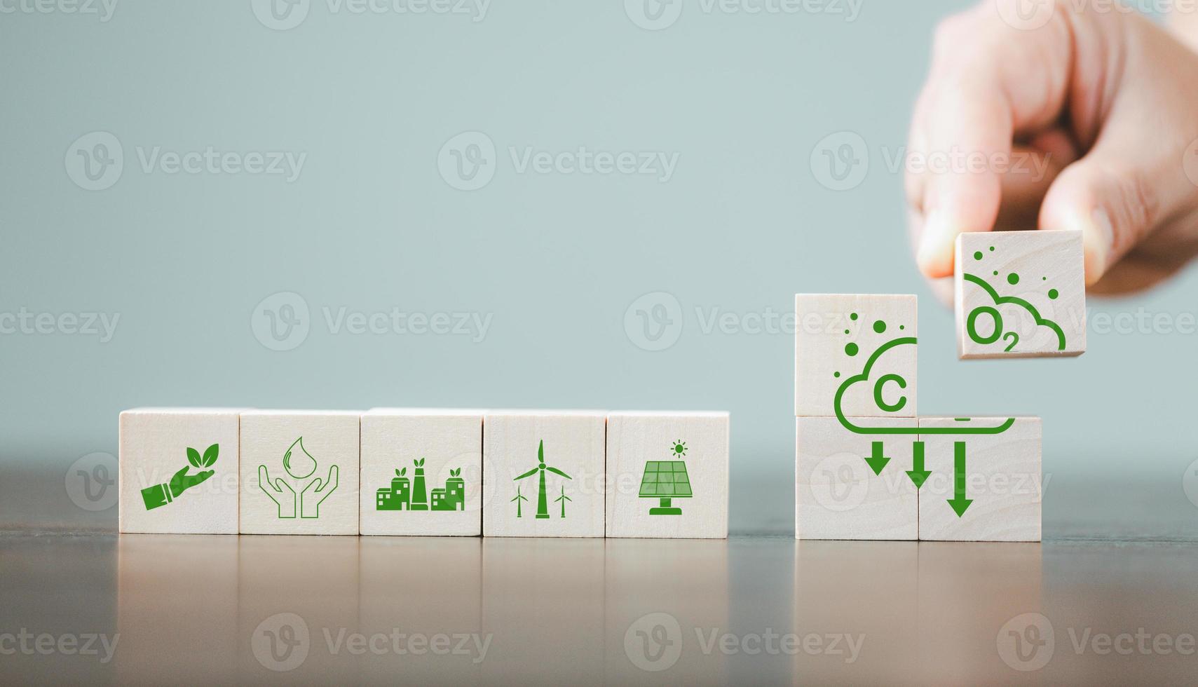 Companies are targeting net zero greenhouse gas emissions. Carbon credit concept.Tradable certificate to drive industry in direction of low emissions in efficiency cost. Wooden cubes with decrease CO2 photo