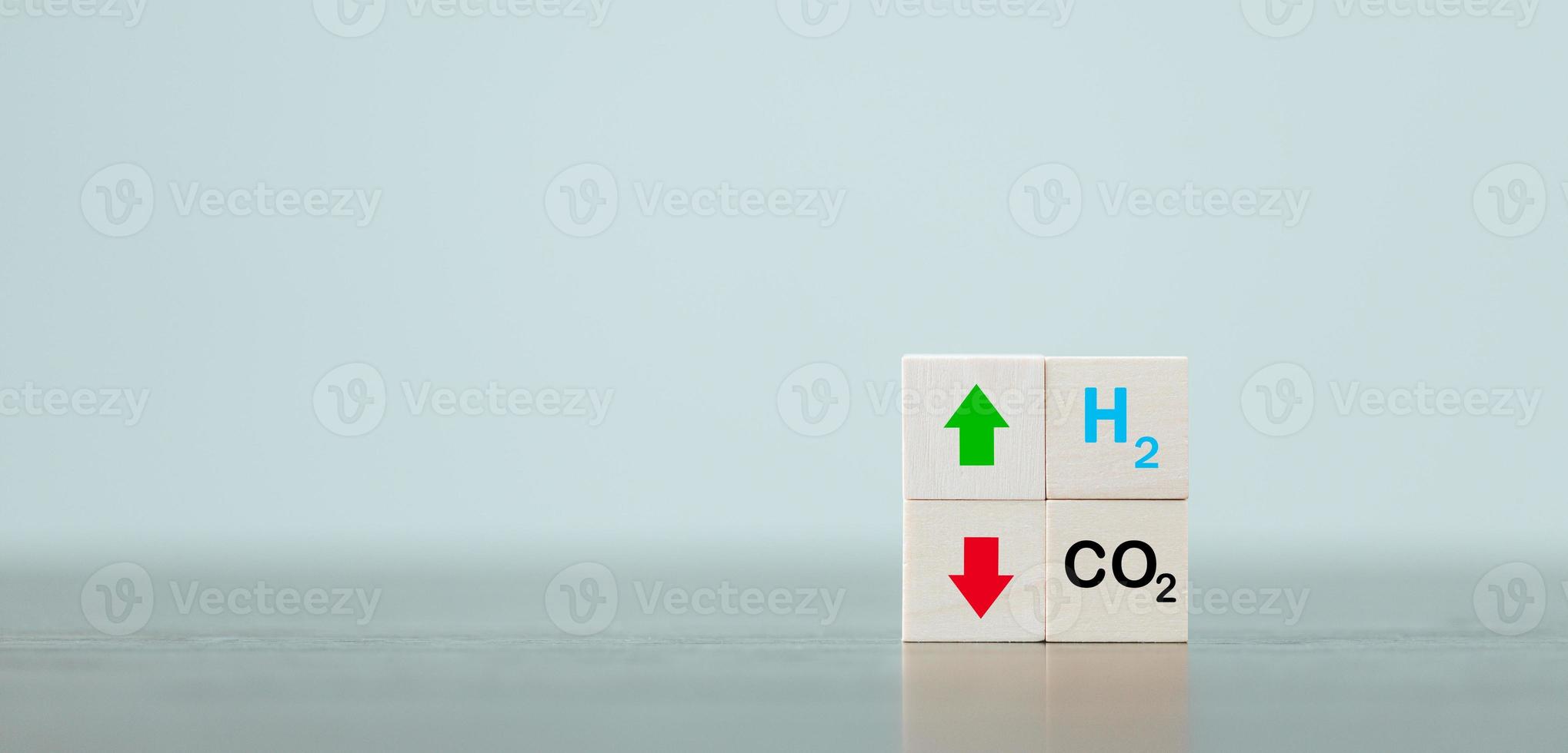 Free Carbon, alternative energy and global climate change concepts. Hand flipping wooden cube blocks with CO2 Carbon dioxide, change to H2 Hydrogen text on table background. Sustainable car energy. photo