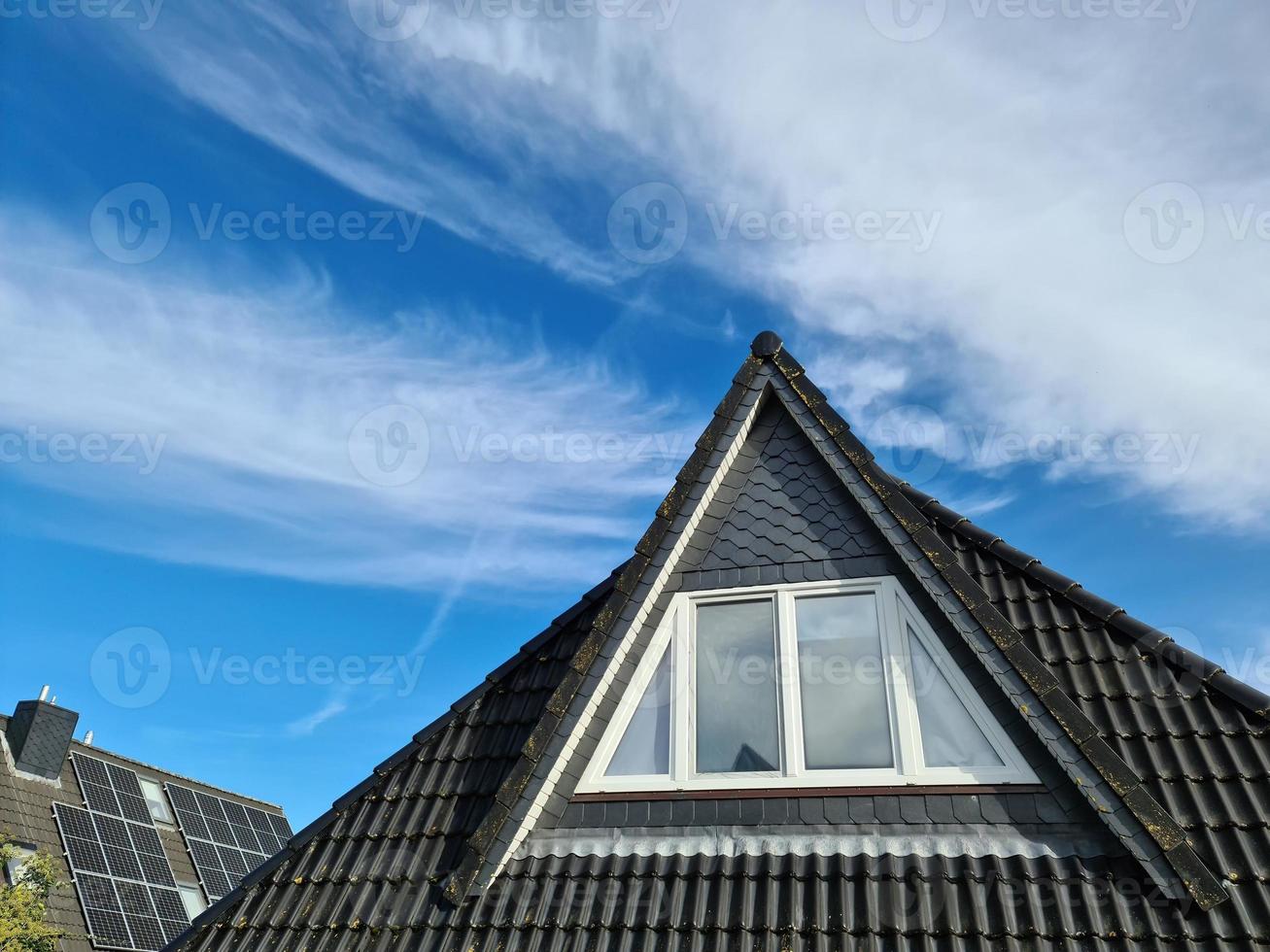 Open roof window in velux style with black roof tiles. photo