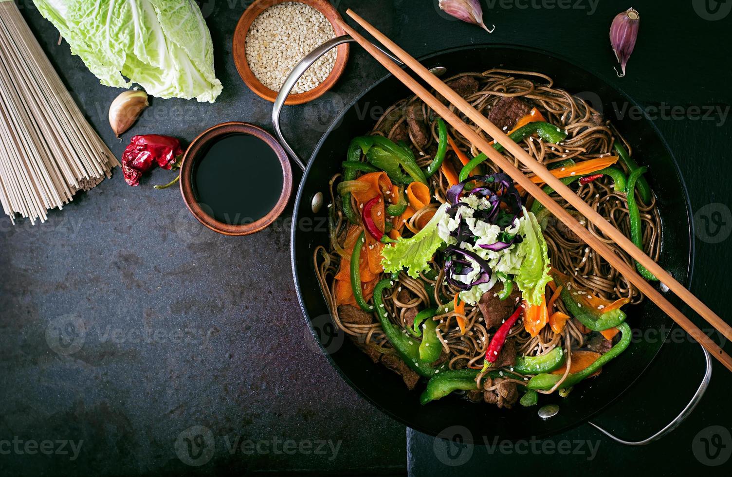 Soba noodles with beef, carrots, onions and sweet peppers photo