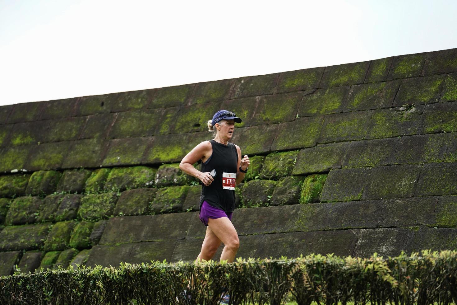 Yogyakarta, Indonesia - November 20, 2022 The Sleman Temple Run contingent passed the scenic route of the Barong temple, they took part in a trail running contest. photo