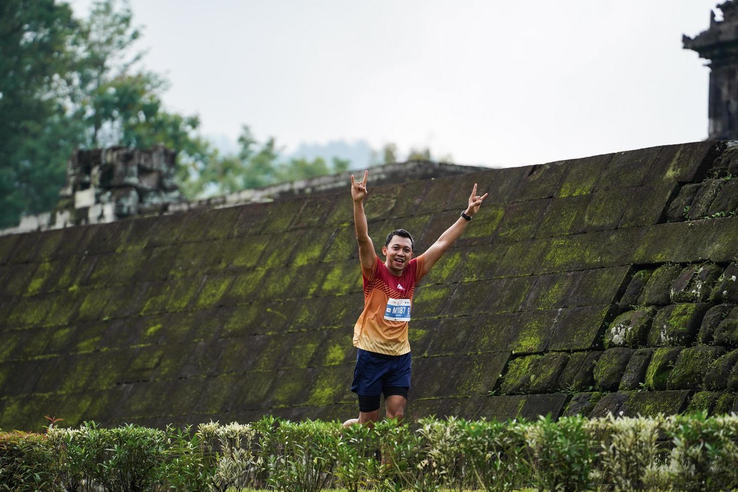 Yogyakarta, Indonesia - November 20, 2022 The Sleman Temple Run contingent passed the scenic route of the Barong temple, they took part in a trail running contest. photo