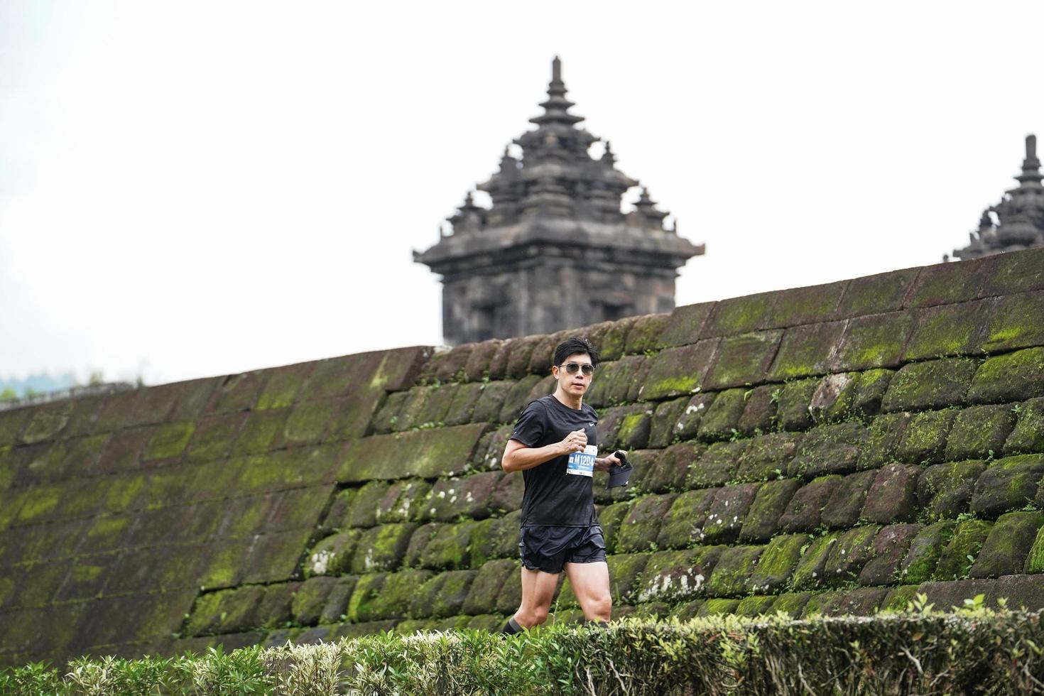 Yogyakarta, Indonesia - November 20, 2022 The Sleman Temple Run contingent passed the scenic route of the Barong temple, they took part in a trail running contest. photo
