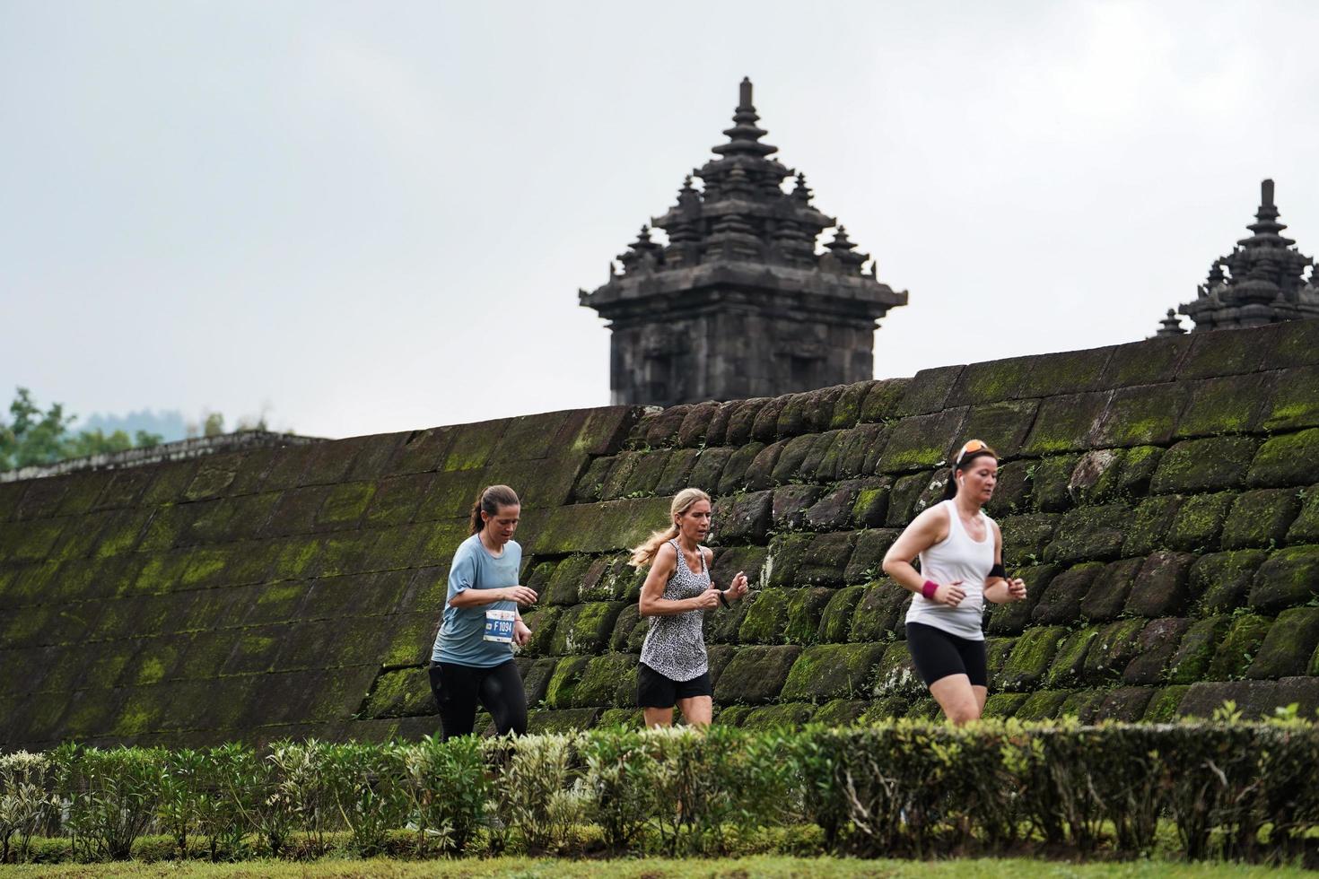 Yogyakarta, Indonesia - November 20, 2022 The Sleman Temple Run contingent passed the scenic route of the Barong temple, they took part in a trail running contest. photo