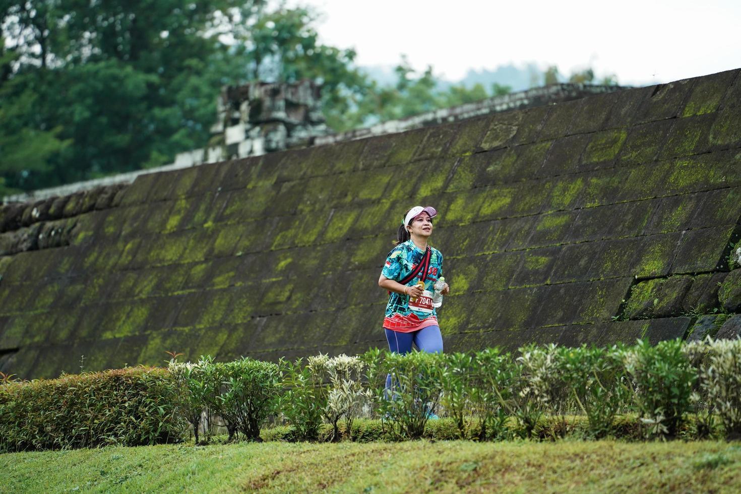 Yogyakarta, Indonesia - November 20, 2022 The Sleman Temple Run contingent passed the scenic route of the Barong temple, they took part in a trail running contest. photo