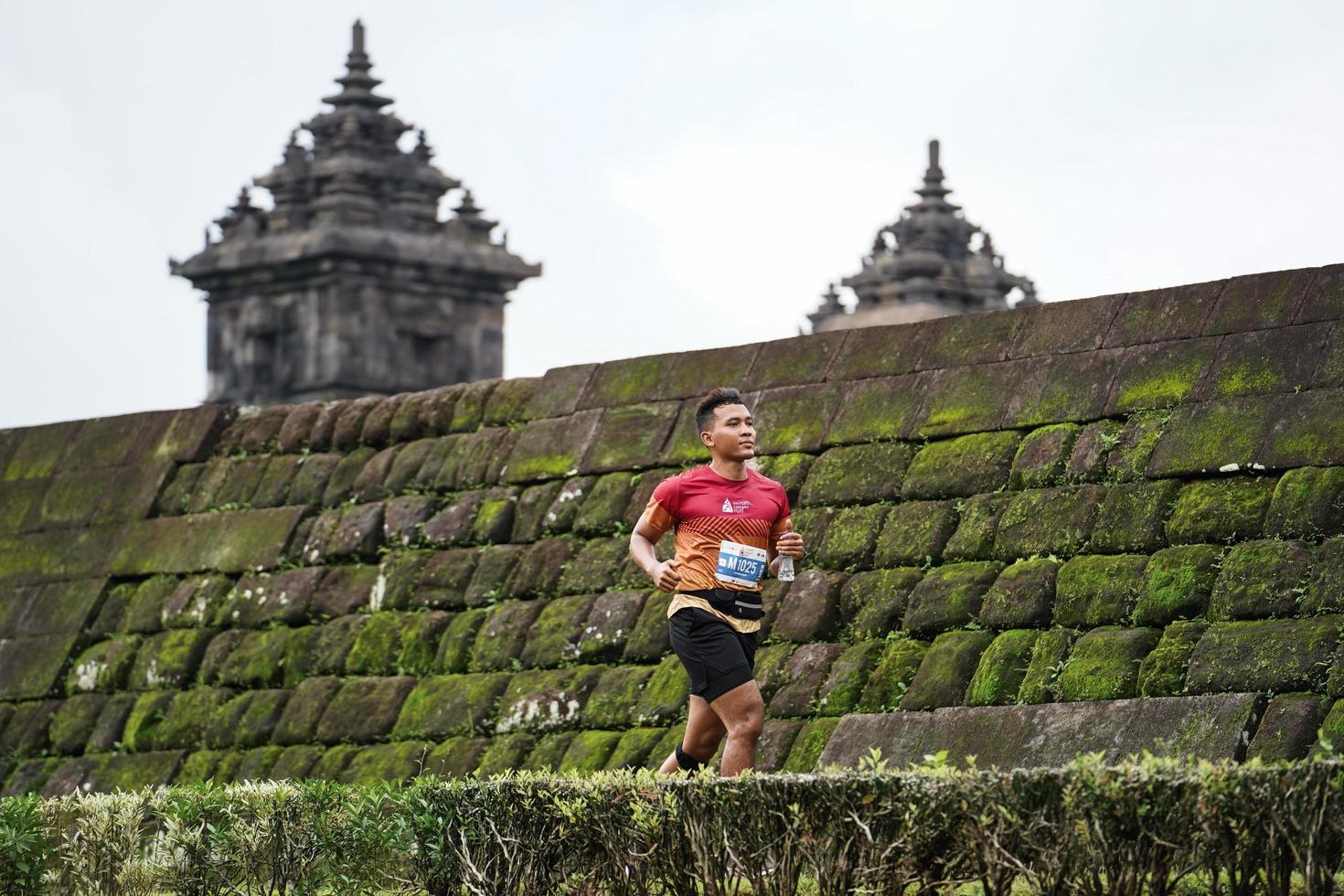 Yogyakarta, Indonesia - November 20, 2022 The Sleman Temple Run contingent passed the scenic route of the Barong temple, they took part in a trail running contest. photo