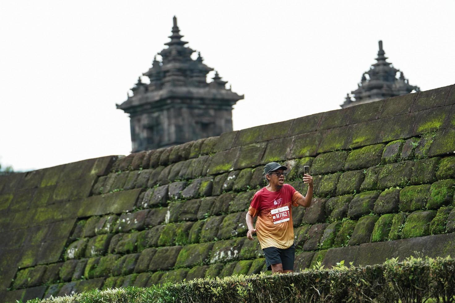 Yogyakarta, Indonesia - November 20, 2022 The Sleman Temple Run contingent passed the scenic route of the Barong temple, they took part in a trail running contest. photo