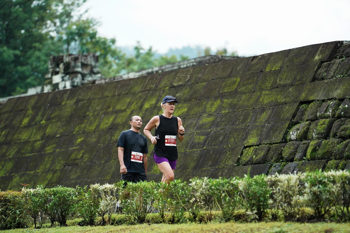 Yogyakarta, Indonesia - November 20, 2022 The Sleman Temple Run contingent passed the scenic route of the Barong temple, they took part in a trail running contest. photo