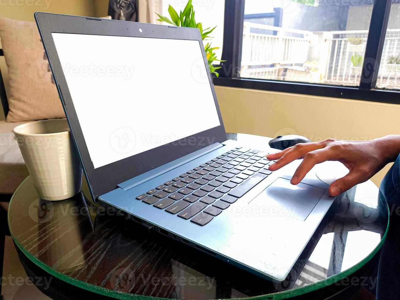 women using laptop computer working at home with blank white desktop screen. photo