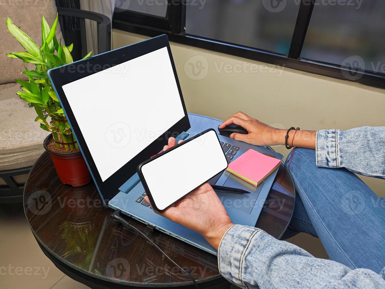 computer, blank screen phone mockup image with white background for advertising, woman's hand using laptop and mobile phone on table in cafe.mockup photo