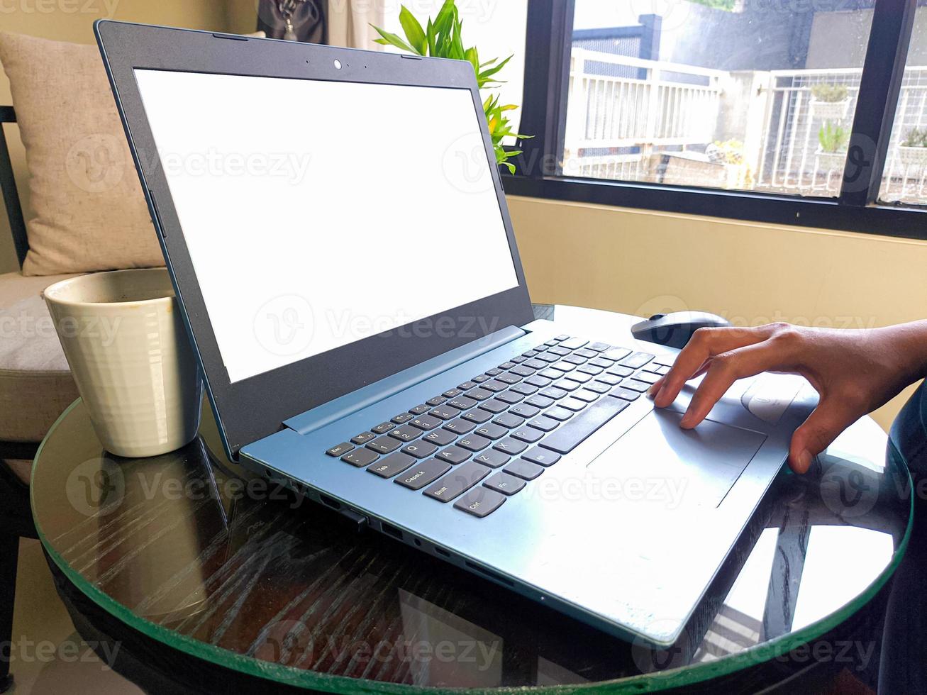 women using laptop computer working at home with blank white desktop screen. photo