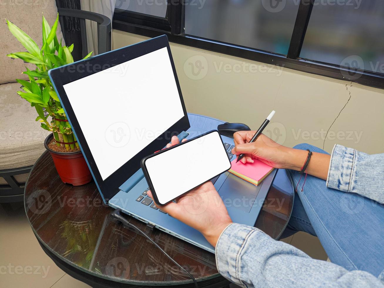 computer, blank screen phone mockup image with white background for advertising, woman's hand using laptop and mobile phone on table in cafe.mockup photo