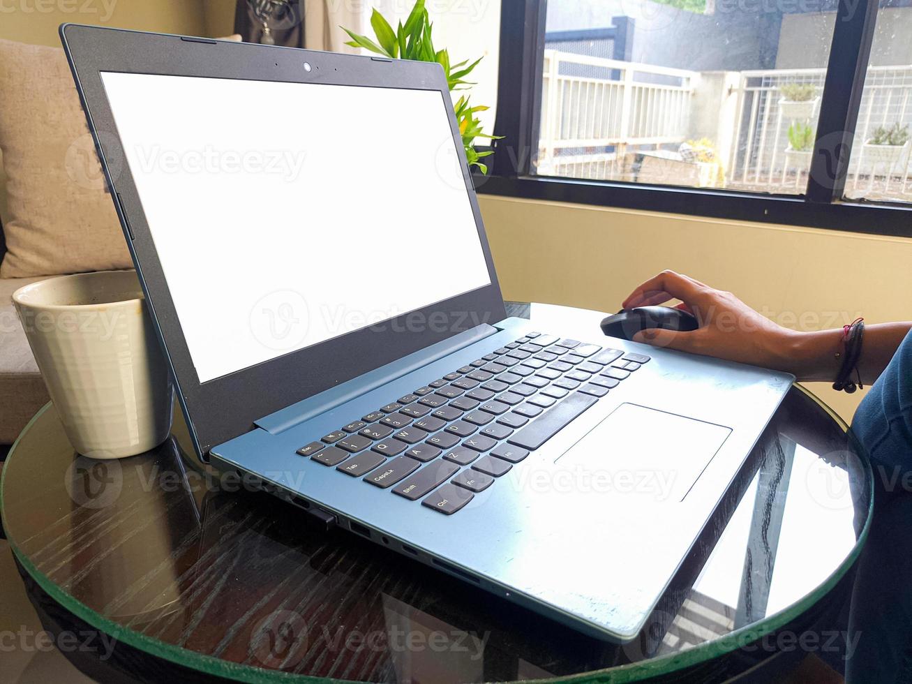 women using laptop computer working at home with blank white desktop screen. photo