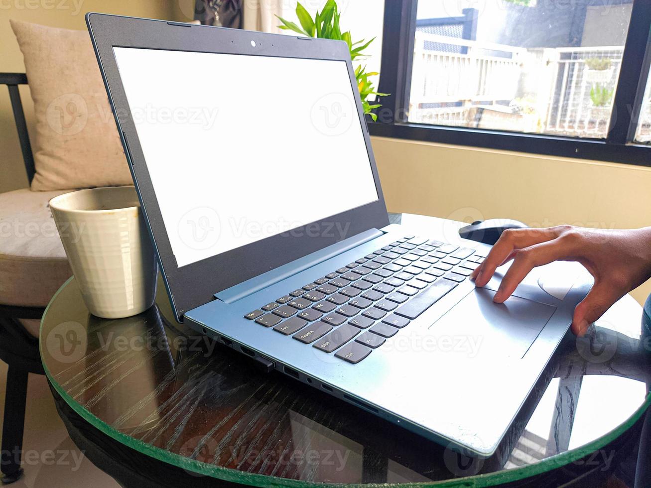 women using laptop computer working at home with blank white desktop screen. photo