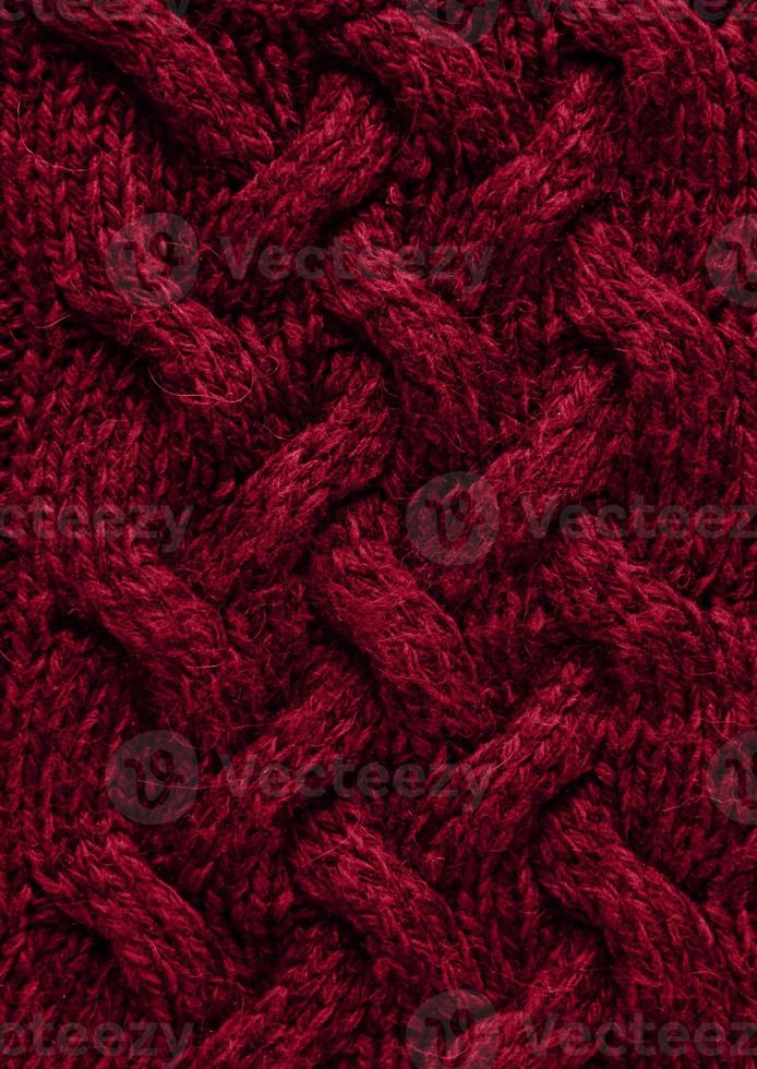 Texture of smooth knitted sweater with pattern. Handmade knitting wool or cotton fabric texture. Background of Large knit pattern with knitting needle or crochet. Color Of The Year 2023 - Viva Magenta photo