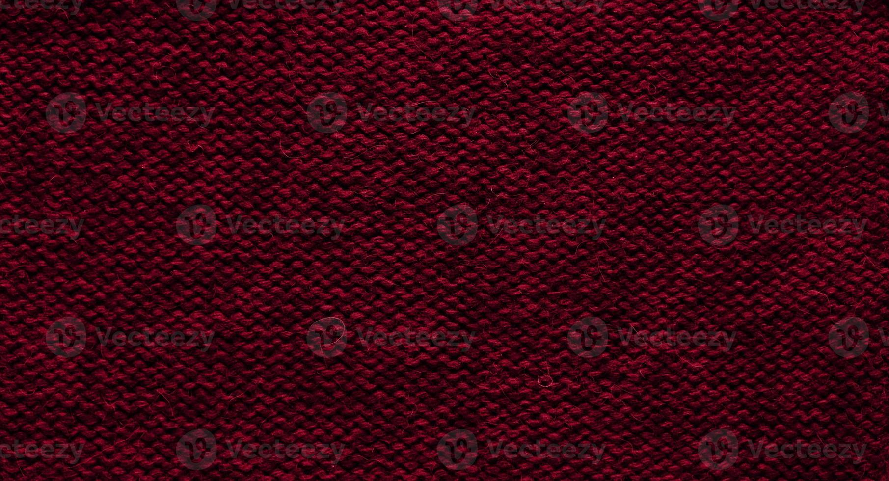 Texture of smooth knitted sweater with pattern. Handmade knitting wool or cotton fabric texture. Background of Large knit pattern with knitting needle or crochet. Color Of The Year 2023 - Viva Magenta photo