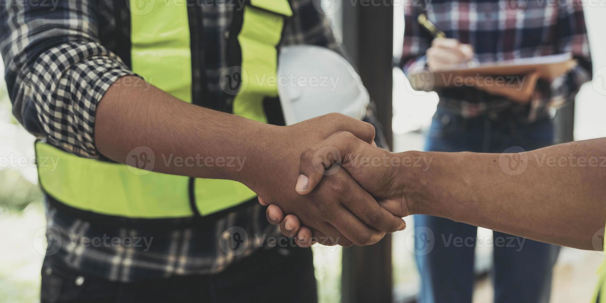 construction worker team hands shaking after consultation meeting to greeting start up plan new project contract in office photo